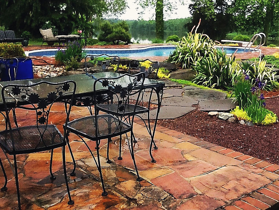Flagstone and brick beside a pool