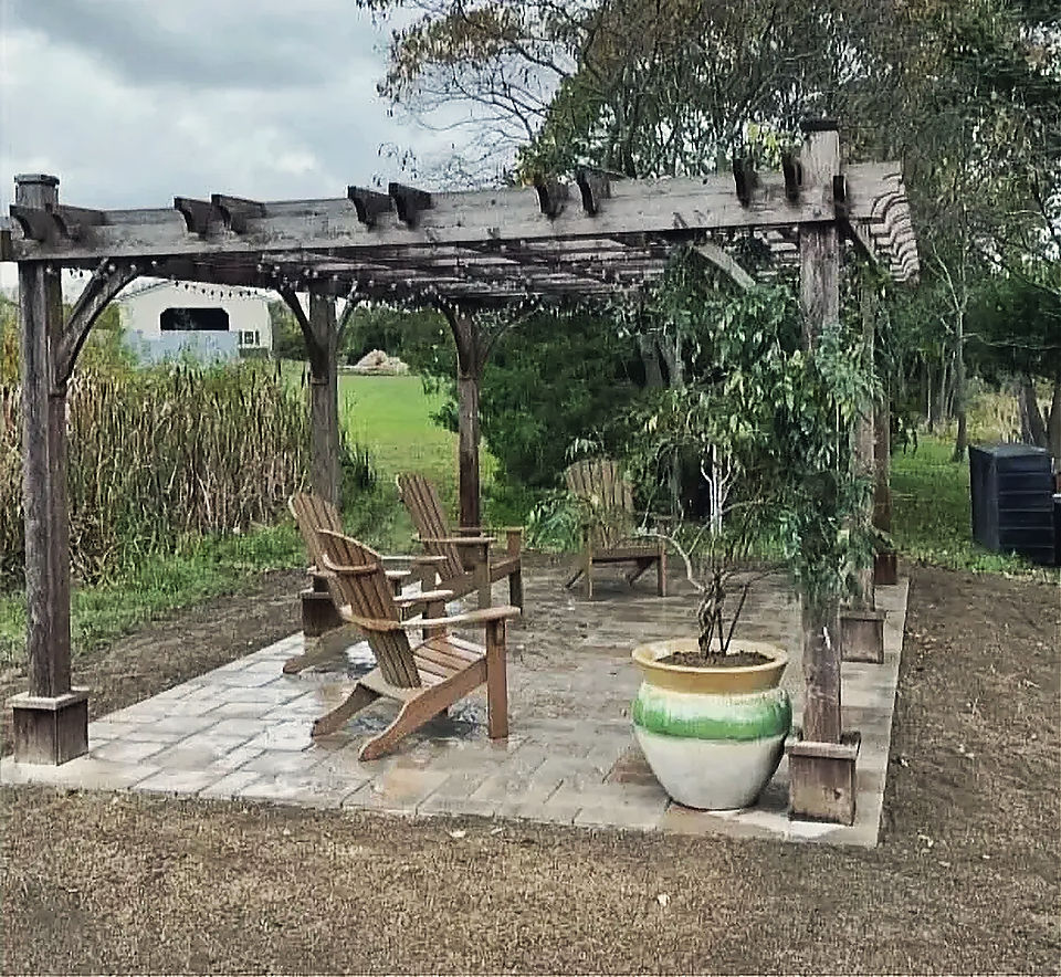 A timber pergola over a paver pad