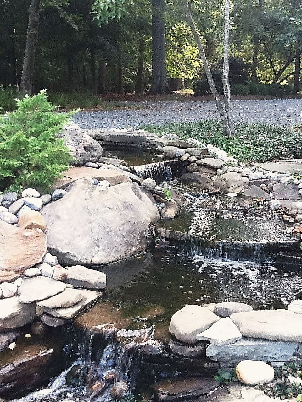 A stone waterfall into a small pond