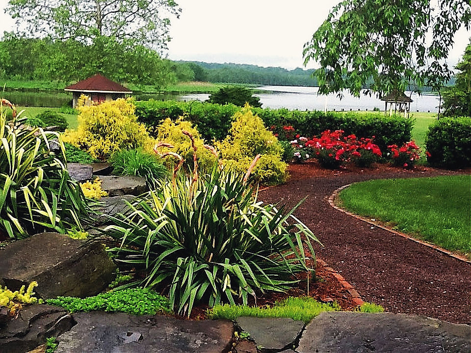 A stone edged bed and a mulch path above the river