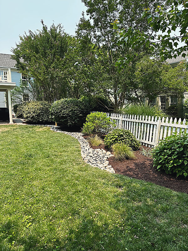 A curved bed line edged in river stone