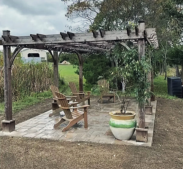 A timber pergola over a paver pad