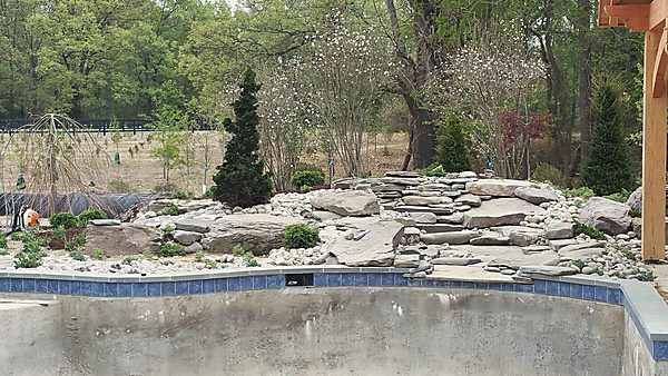 Stone set around a pool shell, before the water
